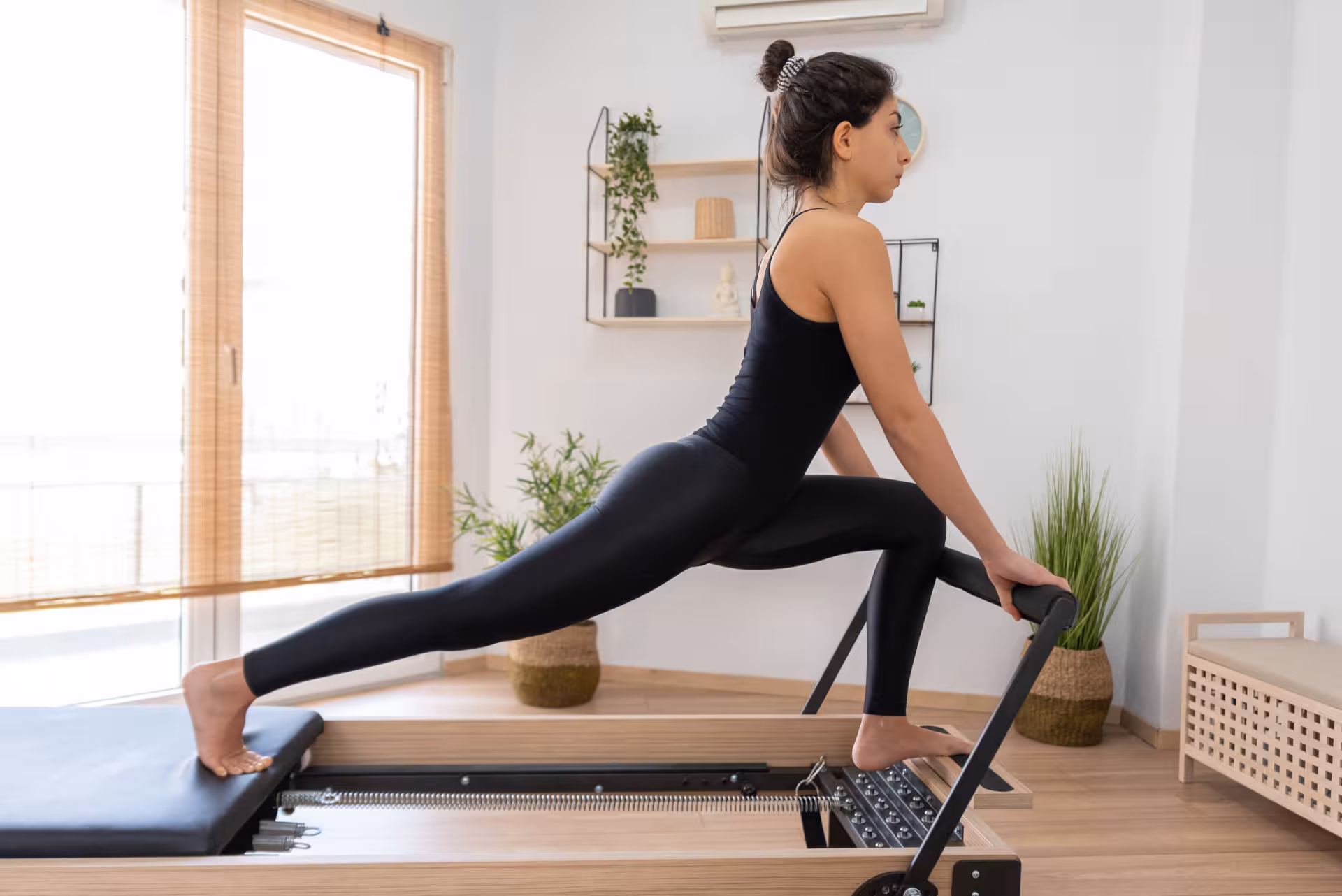 young woman exercising on pilates reformer bed 2025 01 07 07 12 04 utc converted