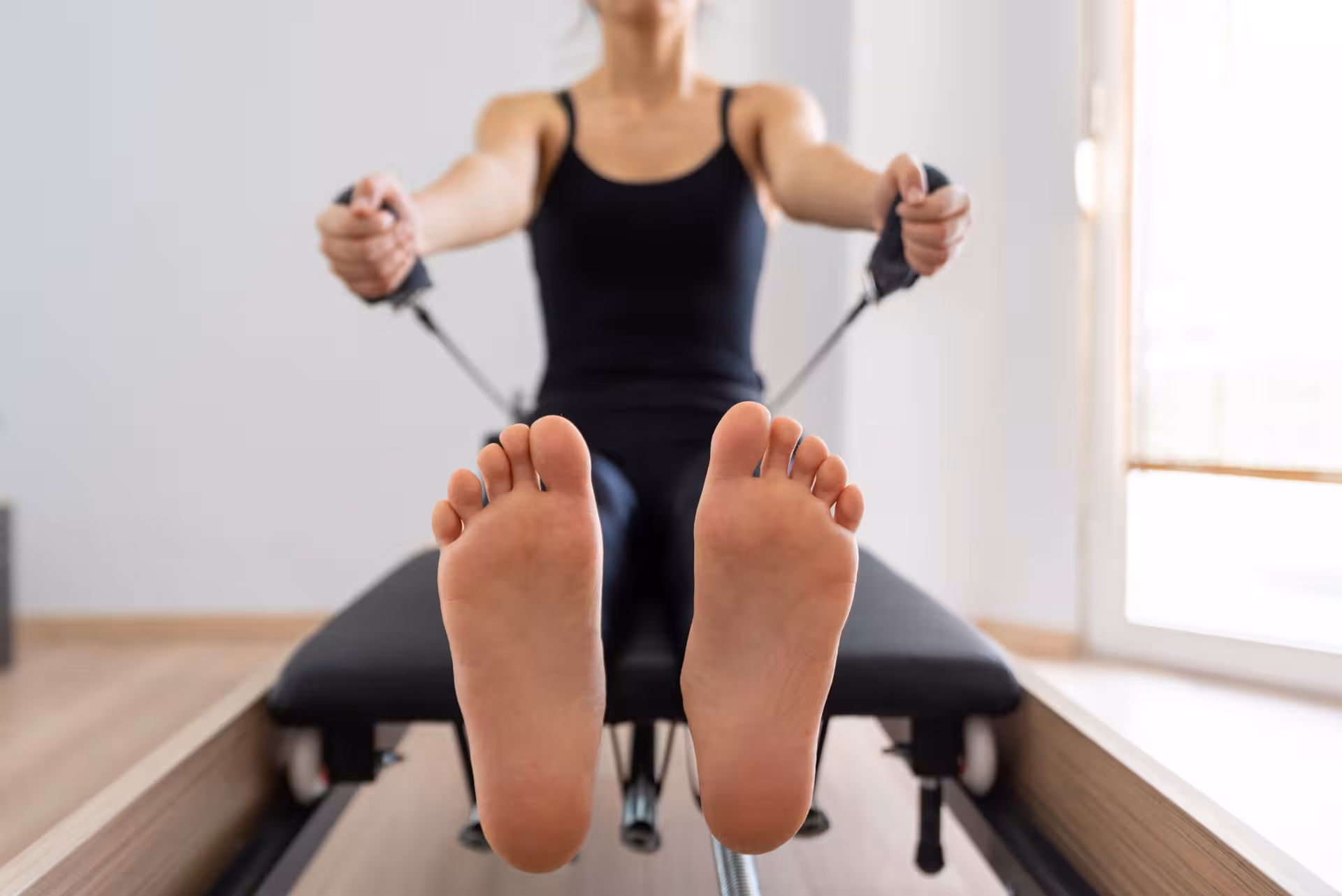 young woman exercising on pilates reformer bed fe 2025 01 09 10 16 15 utc converted